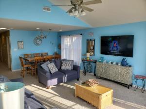 a living room with a couch and a table at Family Friendly Beach Block Ocean View 3 BR, 2 BA, Condo near Wildwood Crest and Convention Center in Wildwood