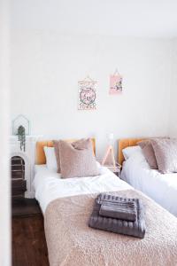 two beds with a tray on top of them in a room at Gorgeous 3 bed house in Matlock + Garden ‘lookout’ in Matlock