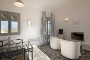 a living room with white furniture and a glass table at Kallisti Daphne · Gorgeous Villa - an oasis for 8 people in Naousa