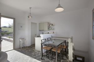 a kitchen and dining room with a table and chairs at Kallisti Daphne · Gorgeous Villa - an oasis for 8 people in Naousa