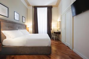 Postel nebo postele na pokoji v ubytování Hotel Embassy