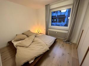 a bed in a room with a window at Ruhiges Penthouse mit Weitblick in Göttingen