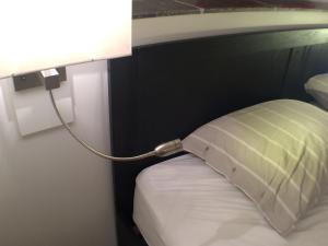 a lamp with a pillow on a bed in a room at B & B Villa Suisse in Scheveningen