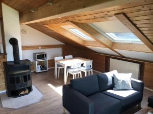 a living room with a couch and a wood stove at Ferienwohnung Nimscholz in Chieming