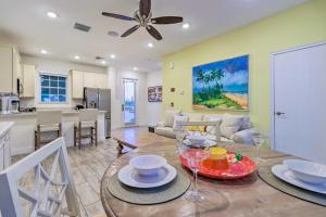 a dining room and living room with a table and a kitchen at Margaritaville Home and Hot Tub, 3 Mi to Disney in Orlando