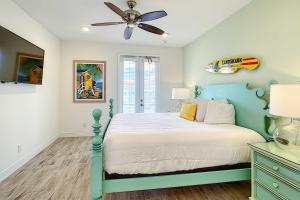 a bedroom with a bed and a ceiling fan at Margaritaville Home and Hot Tub, 3 Mi to Disney in Orlando