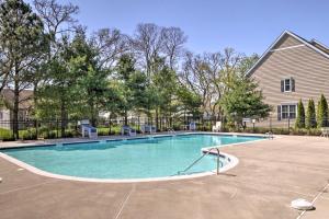 a swimming pool in front of a house at Rehoboth Beach Vacation Rental with Porch! in Rehoboth Beach