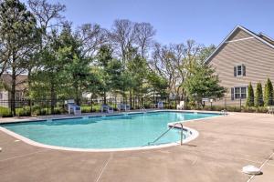 a swimming pool in front of a house at Patio and Pool Access Rehoboth Beach Retreat in Rehoboth Beach