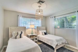 two beds in a bedroom with a window at Bright Boynton Beach Getaway with Patio! in Boynton Beach