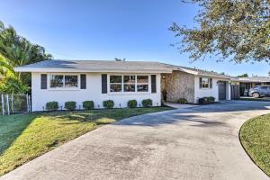 a house with a driveway in front of it at Bright Boynton Beach Getaway with Patio! in Boynton Beach
