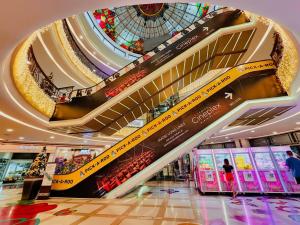 a large shopping mall with a glass ceiling and escalators at NEW Modern Venice Best View and Balcony, Fast Wifi at McKinley Hill 1BR interconnected to Venice Grand Canal Mall in Manila