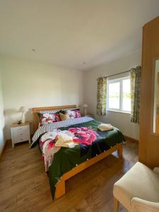a bedroom with a bed and a window at Pine Lodge in Lisnaskea