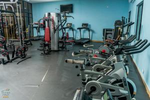 a gym with several treadms and cardio machines at Nyamfinzi Hotel in Chipata