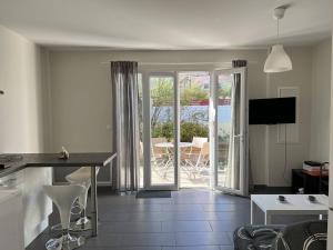 a kitchen and living room with a view of a patio at Appartement Cambo-les-Bains, 2 pièces, 2 personnes - FR-1-495-12 in Cambo-les-Bains