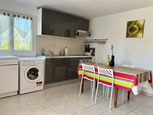 a kitchen with a table and a washing machine at Appartement Ustaritz, 3 pièces, 4 personnes - FR-1-495-7 in Ustaritz