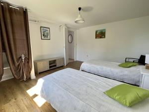 a bedroom with two beds and a room with a window at Appartement Ustaritz, 3 pièces, 4 personnes - FR-1-495-7 in Ustaritz