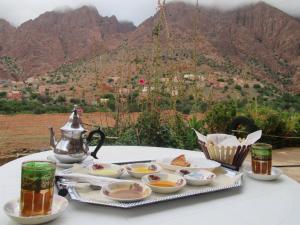 a table with a tray of food and a tea kettle at Auberge Tilila in Tafraout