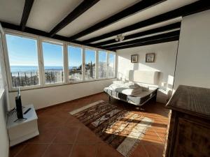 a large living room with a bed and large windows at House with private pool in central Mijas Pueblo in Mijas