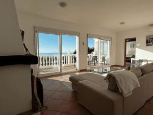 a living room with a couch and a view of the ocean at House with private pool in central Mijas Pueblo in Mijas