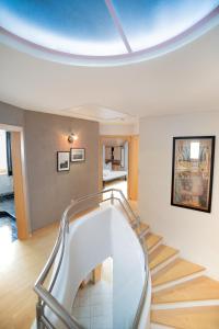 a spiral staircase in a room with a ceiling at Landhaus Anita Dolomiten Kronplatz in Perca