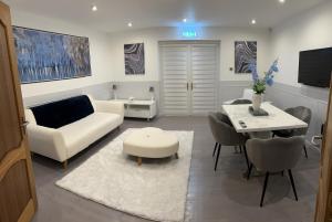 a living room with a couch and a table at Druid House B&B in Inverness