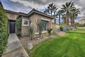 a house with palm trees and a grass yard at Gateway Grand Oasis Private Palm Springs Escape! in Palm Springs