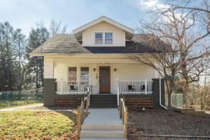 a white house with a porch and a door at Cottage on Main in Lansdale +14 photos