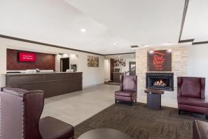 a lobby with a waiting room and a fireplace at Red Roof Inn & Suites Corbin in Corbin