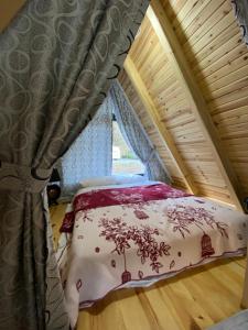 a bed with a canopy in a room with a window at Lelvani Suite Bungalow in Rize