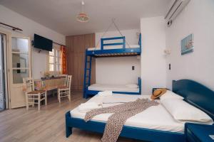 a bedroom with two bunk beds and a desk at Oniropagida in Apollonia
