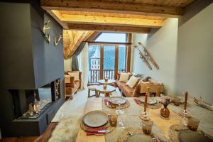 a living room with a couch and a fireplace at WOW views next to the ski lift! in Baqueira-Beret