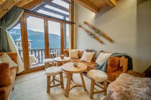 a living room with a couch and a table at WOW views next to the ski lift! in Baqueira-Beret