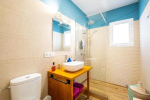 a bathroom with a sink and a toilet and a shower at Casa Flor in Zahora +19 photos