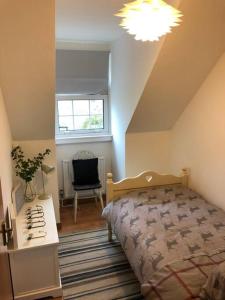 a bedroom with a bed and a desk and a window at Best location in town, it is all on the doorstep. in Ayr