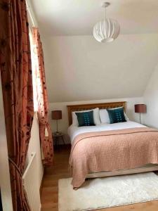 a bedroom with a bed and a chandelier at Best location in town, it is all on the doorstep. in Ayr
