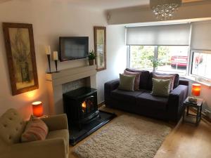 a living room with a couch and a fireplace at Best location in town, it is all on the doorstep. in Ayr