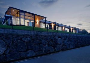 a house on top of a stone wall at night at Balcón de Gijón Apartamentos Boutique in Gijón