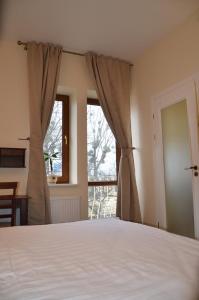 a bedroom with a bed and a window at Hotel MP in Lviv