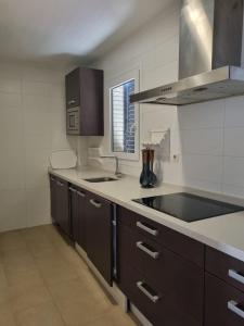 a kitchen with a sink and a counter top at Casa Kizkur in Tarifa