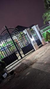 a gate in front of a building at night at Naboya House Serviced Apartment in Benin City