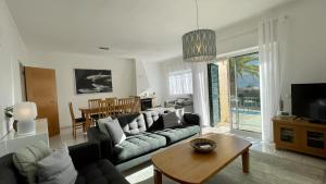a living room with a couch and a table at Margarida by Check-in Portugal in Albufeira
