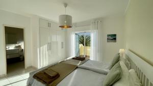 a bedroom with a large bed and a large window at Margarida by Check-in Portugal in Albufeira +37 photos