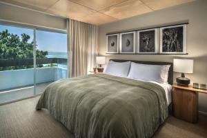 a bedroom with a large bed and a large window at PACIFIC 19 Kona in Kailua-Kona