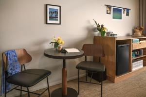 a small table and two stools in a room at PACIFIC 19 Kona in Kailua-Kona