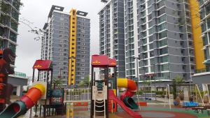 a playground in a city with tall buildings at Vista Alam Studio in Shah Alam