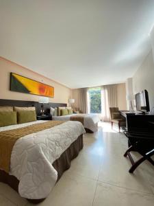 Uma televisão e/ou sistema de entretenimento em Studio Hotel Boutique