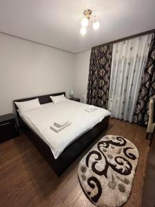 um quarto com uma cama grande e um tapete em Pensiunea Miorița Putna em Putna