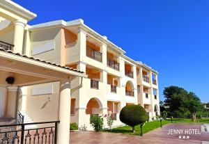 a large white building with balconies on it at Jenny Hotel in Laganas