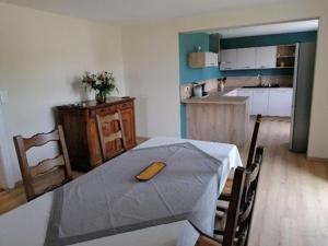 a kitchen with a table with a knife on it at Gîte Les Forges, 3 pièces, 6 personnes - FR-1-589-430 in Les Forges