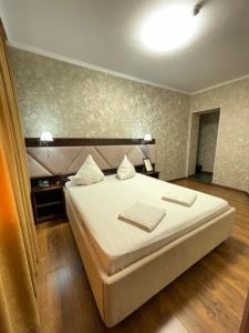 ein Schlafzimmer mit einem Bett mit zwei Handtüchern darauf in der Unterkunft Diar in Atyrau